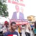 Supporters of the All People's Congress' Dr Samura Kamara carry his campaign poster outside the Atuga Mini Stadium in the east end of Freetown on Monday May 29, 2023. Photo credit, Kemo Cham, ManoReporters. The party has said it wouldn't participate in governance after disputing the June 24 polls.