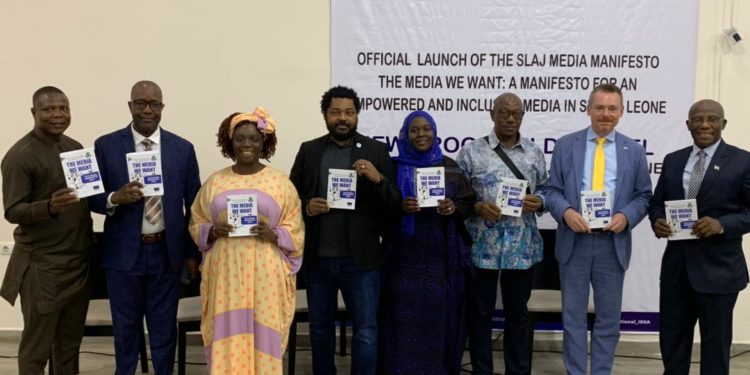 Officials, including SLAJ President Ahmad Sahid Nasralla, Information Minister Abdurahman Swaray and EU Ambassador Manuel Muller, pose with copies of the Media Manifesto following its unveiling. Photo credit, EU Country Delegation