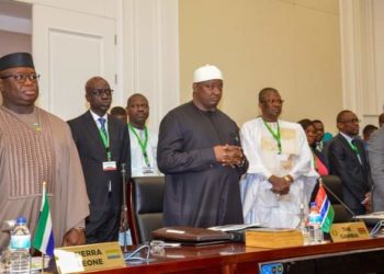President Adama Barrow in Black gown stands near Sierra Leonean counterpart President Julius Maada Bio at the just concluded 63rd ECOWAS Heads of State Summit in Bissau, Guinea Bissau, on Sunday, July 9. Photo credit, ECOWAS Commission.