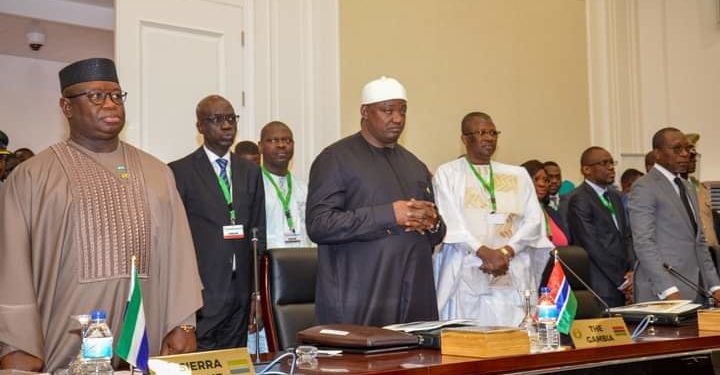 President Adama Barrow in Black gown stands near Sierra Leonean counterpart President Julius Maada Bio at the just concluded 63rd ECOWAS Heads of State Summit in Bissau, Guinea Bissau, on Sunday, July 9. Photo credit, ECOWAS Commission.