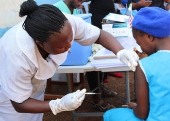 A school pupil being injected with the HPV vaccine at the FAWE Secondary School for girls in Soldier Town, in the East end of Freetown.