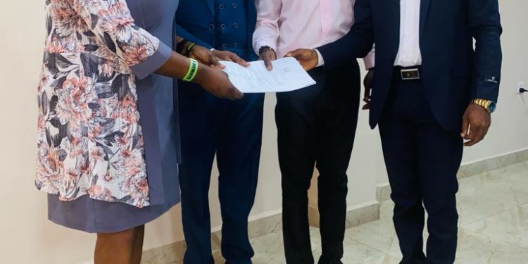 Minister of Social Welfare, Melrose Karminty, hands over an assessment report on child trafficking. Photo credit, Ministry of Social Welfare.