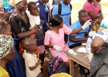 Residents of Kaboreh Village in Karene District line up to be tested for malaria by health workers as part of the Global Fund supported Static Campaign. Photo credit, Kemo Cham, ManoReporters.