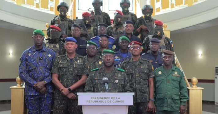 Junta spokesman General Amara Camara, surrounded by military collegaues, reads a presidential decree on Monday, january 19 in Conakry. Screenshot of video image. Kemo Cham, ManoReporters