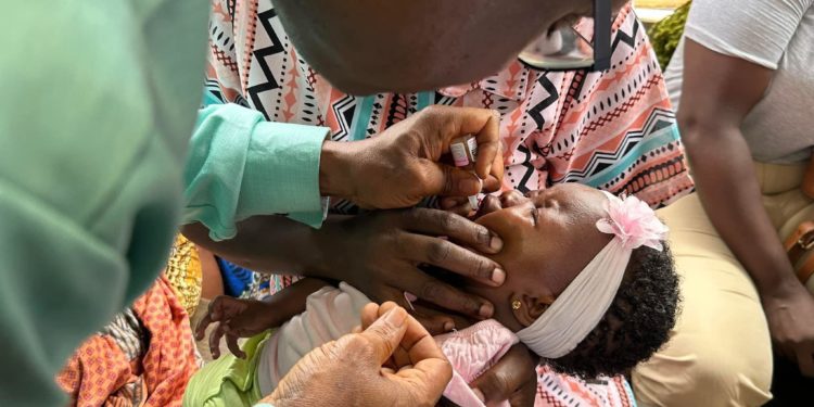 Deputy Minister of Health 1, Charles Senesie, administers the vaccine on a child at the official launching ceremony on Friday, May 10, 2024.