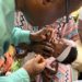 Deputy Minister of Health 1, Charles Senesie, administers the vaccine on a child at the official launching ceremony on Friday, May 10, 2024.