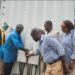 Officials turn on the power after the completion of a mini-grid in Borup community in Port Loko District.. Image, SEforAll.
