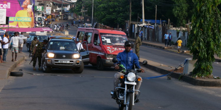 Soldiers search vehicles along the street leading to the Wilberforce Barracks, which was scene of an attack, in aftermath of the failed coup. Image, ManoReporters.