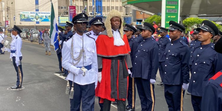 Acting Chief Justice of Sierra Leone, Nicholas C. Browne-Marke, inspects a guard of honor mounted by the personnel of the Sierra Leone police as part of the ceremony marking the beginning of the September session of Criminal cases. Image, Judiciary Communications Unit, Judiciary of Sierra Leone.
