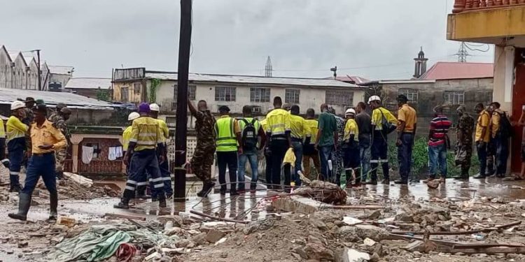 Search and Rescue workers at the scene of the disaster where the seven-story building collapsed in Freetown. Image, NDMA.