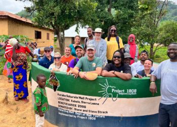Officials of Project 1808 and their partners pose with some members of Karako Sukurala Village at the newly inaugurated water well. Image, Project 1808.