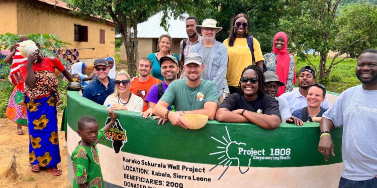 Officials of Project 1808 and their partners pose with some members of Karako Sukurala Village at the newly inaugurated water well. Image, Project 1808.