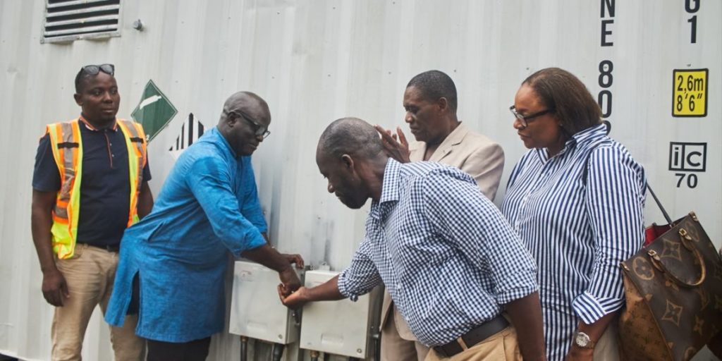  Officials turn on the power after the completion of a mini-grid in Borup community in Port Loko District, on June 7, 22024. Image, SEforAll.