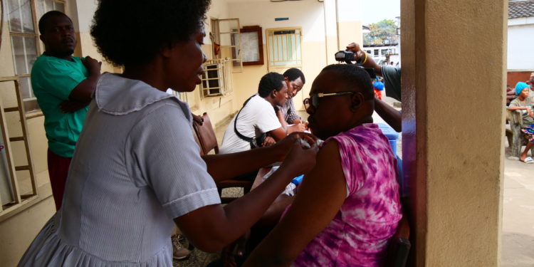 Foday Ambrose Marah, District Operations Officer for the Western Area Urban District Health Management Team, receives his dose of the vaccine at the Princess Christian Maternity Hospital on December, 2024. Image, Dennis Alfred Cole, ManoReporters.