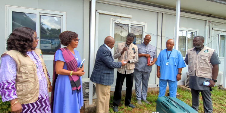 Prof. Foday Sahr, Executive Director of NPHA, receives the donated thermostats from Dr Babacar Fall of ECOWAS RCSDC on Monday, June 23, at the EOC in Freetown. Image, Kemo Cham, ManoReporters.