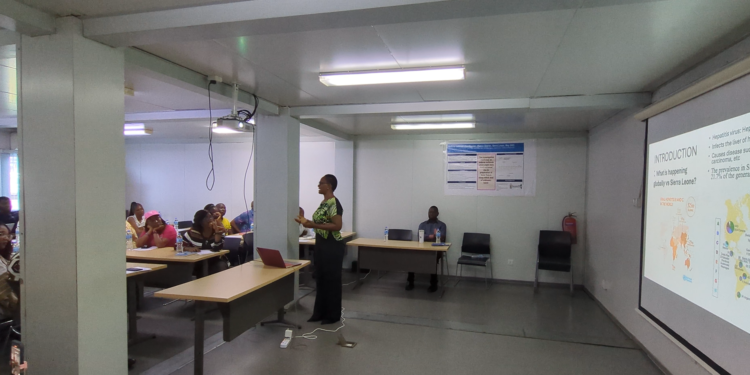 PhD candidate Wachen Peters of the University of Sierra Leone and College of Medicine and Allied Health Sciences and Koinadugu College’s Center for Biomedical and One Health Research is profiling Hepatitis B Genome for the first time in Sierra Leone. Image, screengrab. Kemo Cham, ManoReporters.