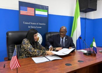 Sierra Leone's Minister of Health Dr Austin Demby exchanges signed copies of the agreement with the US Charge 'dAffairs during the signing ceremony at an in Freetown. Image, MoH Sierra Leone.